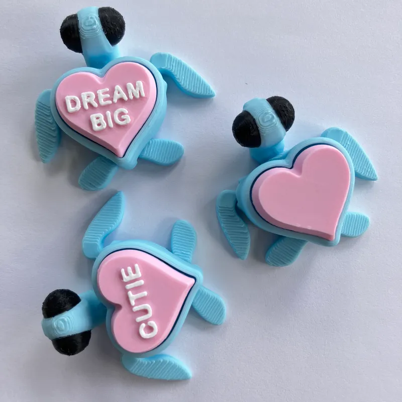 Three blue heart turtles with Dream Big and Cutie shells