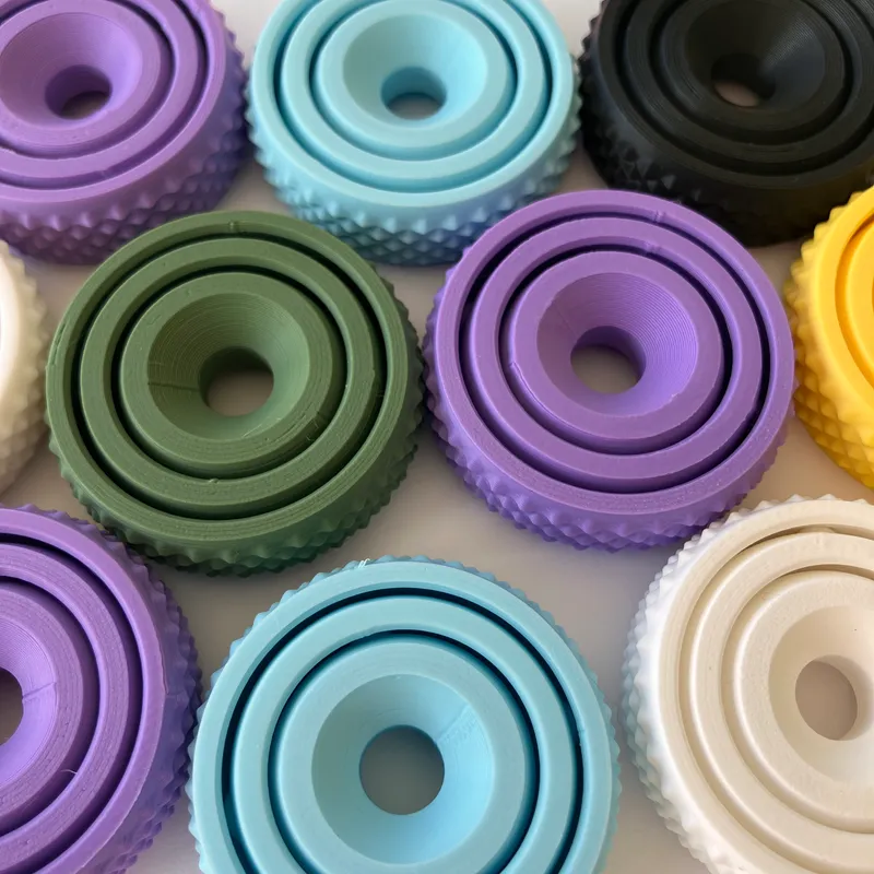 Colourful 3D printed fidget spinners in purple, blue, green, yellow and white